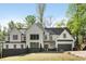Beautiful two-story home featuring a black roof, white siding, black framed windows, and a well-manicured front yard at 4201 Brookview Se Dr, Atlanta, GA 30339