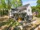 Rear exterior view of a two-story home featuring a covered deck, patio, and landscaped yard at 4201 Brookview Se Dr, Atlanta, GA 30339