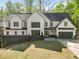 Charming two-story home with a well-manicured lawn, lush landscaping, and a modern exterior design at 4201 Brookview Se Dr, Atlanta, GA 30339