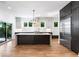 Modern kitchen with an island, stainless steel appliances, custom cabinets, and a sliding door to the deck at 4201 Brookview Se Dr, Atlanta, GA 30339