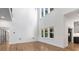 Bright and spacious living area featuring a soaring ceiling, large windows, and hardwood flooring at 4201 Brookview Se Dr, Atlanta, GA 30339