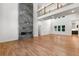 Open living room features a grand fireplace, a balcony, and views into the kitchen and dining areas at 4201 Brookview Se Dr, Atlanta, GA 30339