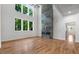 A modern living room boasts high ceilings, hardwood floors, large windows and a stunning floor-to-ceiling stone fireplace at 4201 Brookview Se Dr, Atlanta, GA 30339