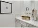 This powder room offers a unique design with a brass bowl sink and black framed art at 4201 Brookview Se Dr, Atlanta, GA 30339