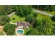 Estate aerial view showcasing the home's setting, pool, and landscaping with surrounding greenery at 5154 Meadowbrook Cir, Suwanee, GA 30024
