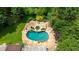 Aerial view of backyard featuring pool, spa, and patio, surrounded by lush greenery at 5154 Meadowbrook Cir, Suwanee, GA 30024
