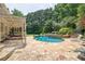 Expansive backyard includes a pool, spa, patio, and lush greenery for outdoor enjoyment at 5154 Meadowbrook Cir, Suwanee, GA 30024