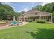 Lush backyard with a pool, and beautiful landscaping offers a serene and private outdoor space at 5154 Meadowbrook Cir, Suwanee, GA 30024