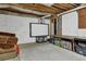 Unfinished basement featuring exposed beams, concrete flooring, and ample storage space at 5154 Meadowbrook Cir, Suwanee, GA 30024