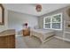 Cozy bedroom featuring neutral decor, a full size bed, and a bright window with natural light at 5154 Meadowbrook Cir, Suwanee, GA 30024