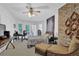 Spacious bedroom with hardwood floors, exposed brick accent wall, and ample natural light at 5154 Meadowbrook Cir, Suwanee, GA 30024