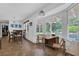 Bright dining area with views of the outdoor pool area, and a table with wood chairs at 5154 Meadowbrook Cir, Suwanee, GA 30024