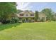Inviting two-story home with well-manicured lawn and classic architectural details at 5154 Meadowbrook Cir, Suwanee, GA 30024