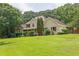 Charming home with a lush green lawn and mature trees providing shade and privacy at 5154 Meadowbrook Cir, Suwanee, GA 30024