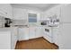Bright kitchen featuring white cabinets, modern appliances, and hardwood floors at 5154 Meadowbrook Cir, Suwanee, GA 30024