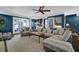 Comfortable living room featuring neutral sectional sofa, built-in shelving, and French doors at 5154 Meadowbrook Cir, Suwanee, GA 30024