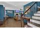 Open living space with wood floors, fireplace, staircase and stylish decor at 5154 Meadowbrook Cir, Suwanee, GA 30024