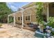 Charming covered patio with stone flooring is ideal for outdoor seating and relaxation at 5154 Meadowbrook Cir, Suwanee, GA 30024