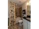 Well-lit bathroom with granite countertops, shower-tub combination, and tile flooring at 5268 Mulberry Pass Ct, Hoschton, GA 30548