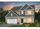 Charming two-story home with a brick facade, a two-car garage, and a landscaped yard at 5268 Mulberry Pass Ct, Hoschton, GA 30548