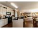 Open-concept kitchen with granite countertops, stainless steel appliances, and hardwood flooring at 5268 Mulberry Pass Ct, Hoschton, GA 30548