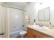 Bright bathroom features a tub with shower, modern sink and vanity, and neutral color scheme at 1150 Collier Nw Rd # G8, Atlanta, GA 30318