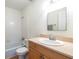 Well-lit bathroom featuring a tub with shower and a wooden vanity with a modern sink and mirror at 1150 Collier Nw Rd # G8, Atlanta, GA 30318