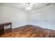 Bedroom showcasing laminate flooring, a ceiling fan, natural light from the window, and closet doors at 1150 Collier Nw Rd # G8, Atlanta, GA 30318