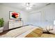 Bedroom featuring wall art, laminate flooring, a ceiling fan, and natural light from the window at 1150 Collier Nw Rd # G8, Atlanta, GA 30318