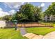 Fully-fenced dog park with green grass and shade trees at 1150 Collier Nw Rd # G8, Atlanta, GA 30318