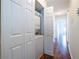 Hallway features a closet with stacked washer and dryer, and hardwood floors at 1150 Collier Nw Rd # G8, Atlanta, GA 30318