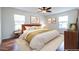 Staged bedroom with large windows, ceiling fan, and hardwood floors at 1150 Collier Nw Rd # G8, Atlanta, GA 30318