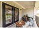 Stylish outdoor patio with seating, potted plants, and view through glass doors at 1150 Collier Nw Rd # G8, Atlanta, GA 30318