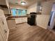 Cozy kitchen featuring white cabinets, a vintage stove, and a window that offers views of the outdoors at 3705 Orchard Dr, Atlanta, GA 30349