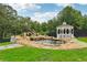 Landscaped backyard with a tranquil pond, waterfall feature, and gazebo, perfect for relaxation and outdoor enjoyment at 3735 Hamilton Mill Rd, Buford, GA 30519