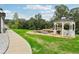 Manicured backyard featuring a serene pond with waterfall and a charming gazebo surrounded by lush greenery at 3735 Hamilton Mill Rd, Buford, GA 30519