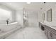 Elegant bathroom with marble tile, soaking tub, walk-in shower, and dual vanity at 3735 Hamilton Mill Rd, Buford, GA 30519
