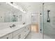 Bright bathroom features a double vanity with marble countertop and sleek black fixtures, plus a frameless glass shower at 3735 Hamilton Mill Rd, Buford, GA 30519