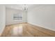 Bright bedroom featuring wood floors, natural light, and modern chandelier at 3735 Hamilton Mill Rd, Buford, GA 30519