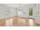 Bright dining room features a modern chandelier, light wood floors, and access to the backyard at 3735 Hamilton Mill Rd, Buford, GA 30519