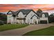 Stunning two-story home boasts modern farmhouse design with white brick, black accents, and lush front lawn at 3735 Hamilton Mill Rd, Buford, GA 30519
