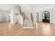 Grand foyer featuring hardwood floors, modern staircase, and an arched front door at 3735 Hamilton Mill Rd, Buford, GA 30519