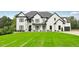 Charming two-story home with a manicured lawn, elegant entryway, and a three-car garage at 3735 Hamilton Mill Rd, Buford, GA 30519
