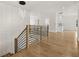 Open hallway featuring modern railing, stylish light fixture, and hardwood floors at 3735 Hamilton Mill Rd, Buford, GA 30519