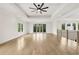 Upstairs hallway featuring modern railing, hardwood floors, and natural light at 3735 Hamilton Mill Rd, Buford, GA 30519
