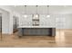 Bright open kitchen featuring an oversized island, pendant lighting, and modern stainless steel appliances at 3735 Hamilton Mill Rd, Buford, GA 30519