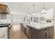 Open kitchen with a large island, stainless appliances, custom cabinetry, and a farmhouse sink at 3735 Hamilton Mill Rd, Buford, GA 30519