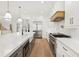 Modern kitchen featuring an oversized island with white countertops, stainless appliances, and hardwood flooring at 3735 Hamilton Mill Rd, Buford, GA 30519
