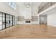 Bright open living room featuring a fireplace, floor-to-ceiling windows, high ceilings and hardwood flooring at 3735 Hamilton Mill Rd, Buford, GA 30519