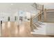 Spacious living room with hardwood floors, iron stair railings, and many windows for natural light at 3735 Hamilton Mill Rd, Buford, GA 30519